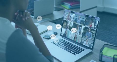 Remote team meeting on laptop in modern office environment