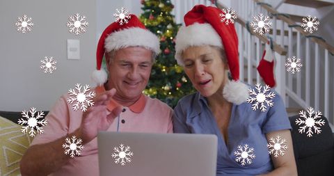 Senior Couple in Santa Hats Enjoying Virtual Christmas Celebration