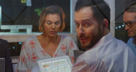 Diverse Team Analyzing Data with Digital Graph Interface