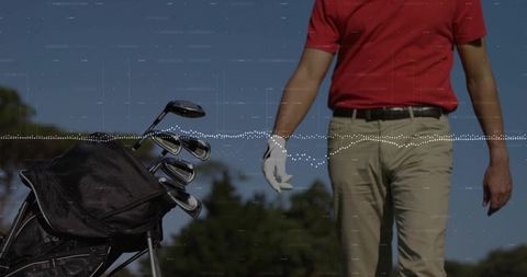 Senior golfer in red polo enjoying day on golf course