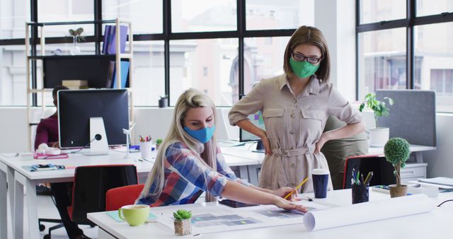 Coworkers Collaborating on Project with Face Masks in Modern Office - Download Free Stock Images Pikwizard.com