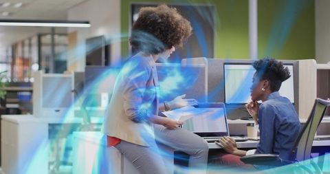 Collaborating team discussing laptop and documents in modern open office with blue overlay