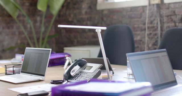 Contemporary Office Workspace with Laptops and Telephones - Download Free Stock Images Pikwizard.com