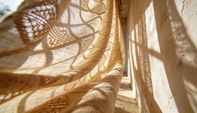 Billowing sheer curtain casting intricate lace shadows along sunlit narrow passage