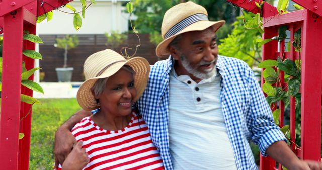 Happy senior couple walking in the garden