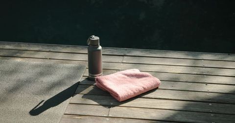 Outdoor Fitness Still Life with Yoga Mat, Towel, and Water Bottle