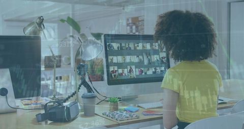 Businesswoman Analyzing Financial Data on Office Computer Screens