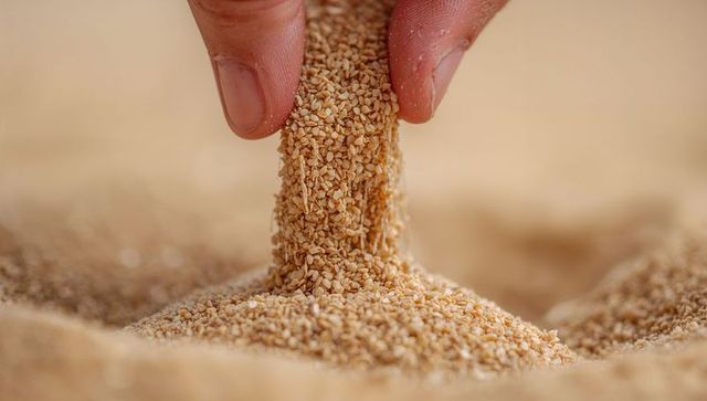 Pinching Fingertips Releasing Sesame Grains, Macro Closeup of Semolina Texture Flow Detail