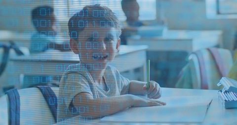 Elementary Student Writing at Desk with Digital Binary Overlay Representing Tech Learning