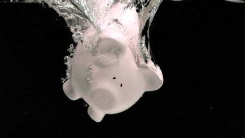 Piggy Bank Splashing into Water in Slow Motion