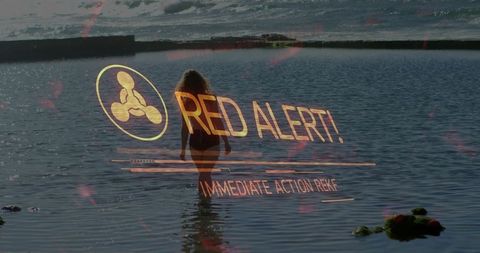 Woman walking in water with red alert safety overlay