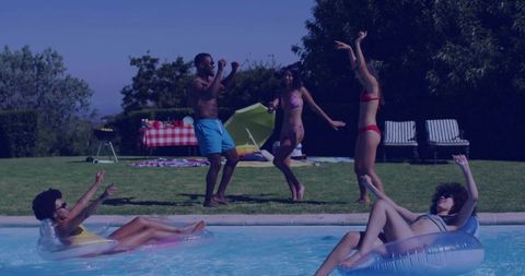 Group of Friends Relaxing and Dancing by Summer Pool