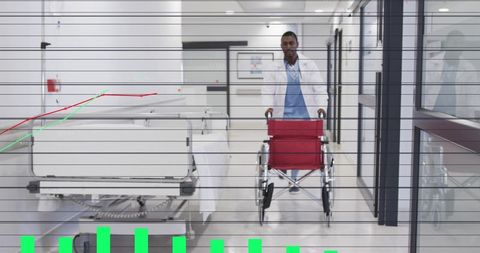Doctor pushing red wheelchair down hospital corridor with bed and glass reflections