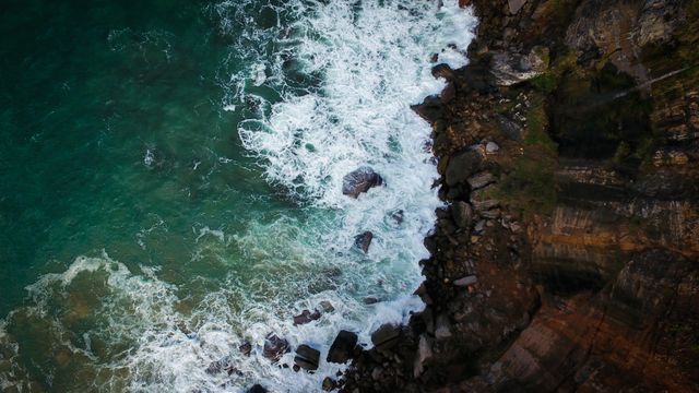 Aerial View of Rocky Coastline with Crashing Waves - Download Free Stock Photos Pikwizard.com