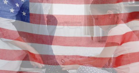 Child Helping Father Tie Shoes with American Flag Overlay