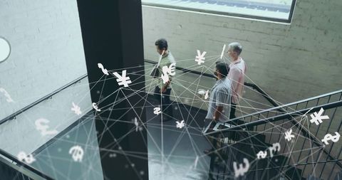 Business Team in Industrial Setting with Global Currency Symbols