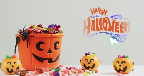 Festive Halloween Pumpkin Bucket With Candy Overflow - Download Free Stock Images Pikwizard.com