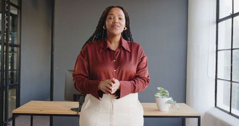 Confident Businesswoman Giving Presentation in Modern Workspace