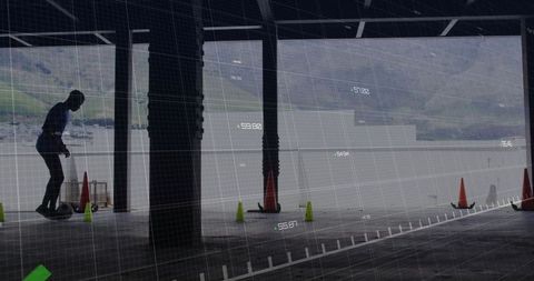 Man skillfully riding self-balancing board in waterside warehouse