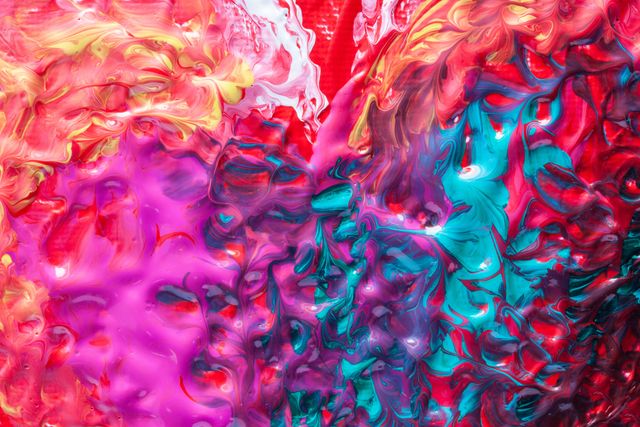 This abstract image showcases a vibrant mix of acrylic paint creating a swirling, highly-textured pattern. The mix of purples, blues, reds, and yellows can be used as a dynamic background for graphic design or promotional materials. Ideal for inspiring creativity, it lends itself well to modern art projects, digital branding, posters, or contemporary home decor.
