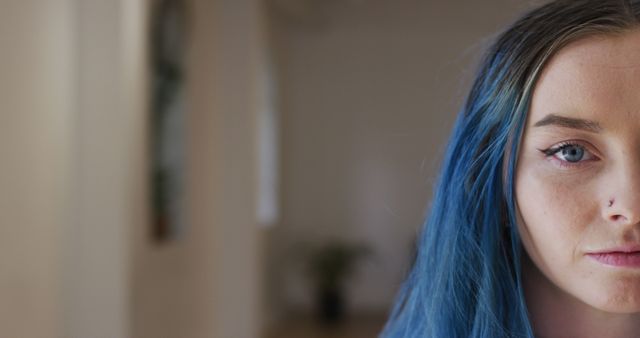 Young Woman with Blue Hair and Nose Piercing Looking Serious - Download Free Stock Images Pikwizard.com