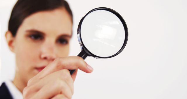 Close-up of Woman Examining Object with Magnifying Glass - Download Free Stock Images Pikwizard.com