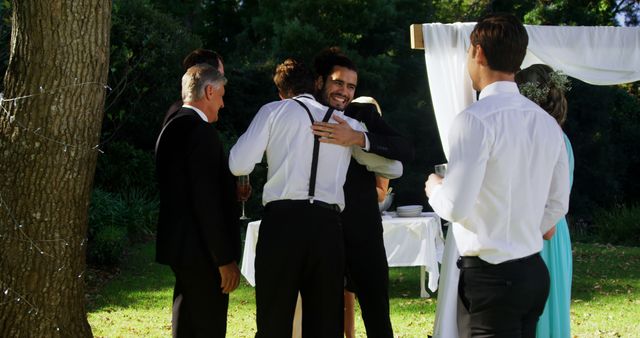 Groomsmen Hugging Each Other during Outdoor Wedding Ceremony - Download Free Stock Images Pikwizard.com