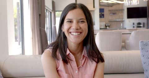 Teenage Girl Relaxing Cheerfully at Home on Contemporary Couch
