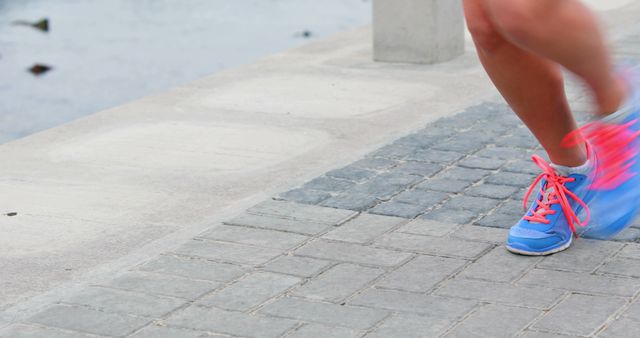 Close-up of Runner’s Feet with Colorful Shoes on Paved Path - Download Free Stock Images Pikwizard.com