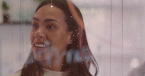 Smiling woman gazing right with vintage film grain overlay, warm indoor lifestyle portrait