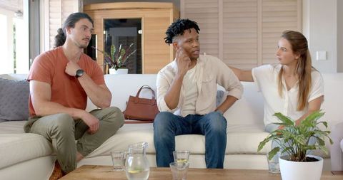 Friends Bonding While Sharing Comfort on Living Room Sofa