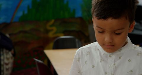 Young boy engaged in music class learning to play xylophone