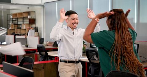 Excited Coworkers Celebrating Major Office Milestone