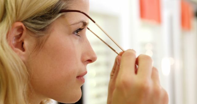 Close-up of Woman Trying on Glasses in Optometry Store - Download Free Stock Images Pikwizard.com