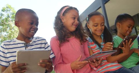 Diverse Group of Kids Sharing Tablets Outdoors Smiling - Download Free Stock Images Pikwizard.com