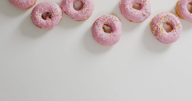 Tasty Pink Frosted Donuts with Colorful Sprinkles on White Background - Download Free Stock Images Pikwizard.com