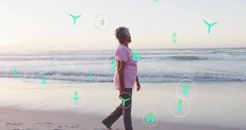 Senior woman walking sunrise beach with green energy health and wellness icons