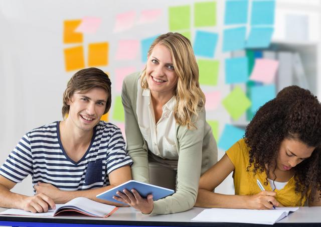 Cheerful Teacher with College Students in Classroom - Download Free Stock Photos Pikwizard.com