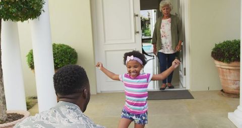 young girl joyfully welcoming returning soldier home - Download Free Stock Images Pikwizard.com