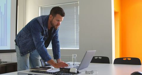 Business Executive working on Laptop in Modern Office