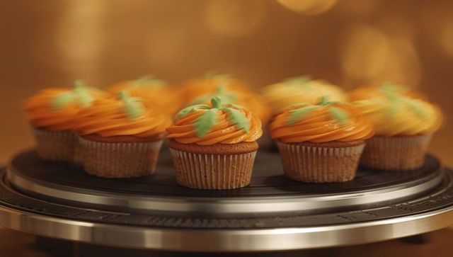 Gourmet Pumpkin Cupcakes on Display Stand with Swirling Motion
