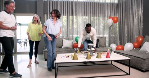 Diverse Group Preparing for Celebration in Modern Living Room