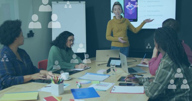 A diverse group of professionals attending a business presentation in a modern office environment. A woman is presenting on a digital screen while colleagues are attentively listening, taking notes, and discussing. Ideal for illustrating business teamwork, professional meetings, corporate training, or collaborative projects.