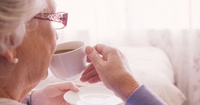 Senior woman having a cup of tea at home - Download Free Stock Photos Pikwizard.com