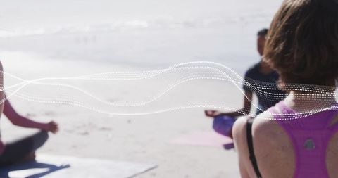 Group practicing beach yoga with dotted wave overlay, pastel light and coastal mindfulness