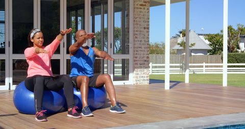 Outdoor Fitness Activity: Mature Couple Exercising with Stability Ball