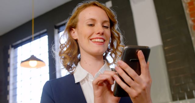 Businesswoman Checking Smartphone and Smiling - Download Free Stock Images Pikwizard.com