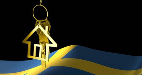 Golden key to home and swedish flag symbolizing property investment