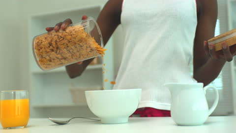 Woman Preparing Healthy Breakfast With Cereal and Orange Juice