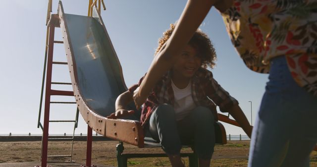 Smiling Child Ready to Slide with Helping Hand on Playground - Download Free Stock Images Pikwizard.com